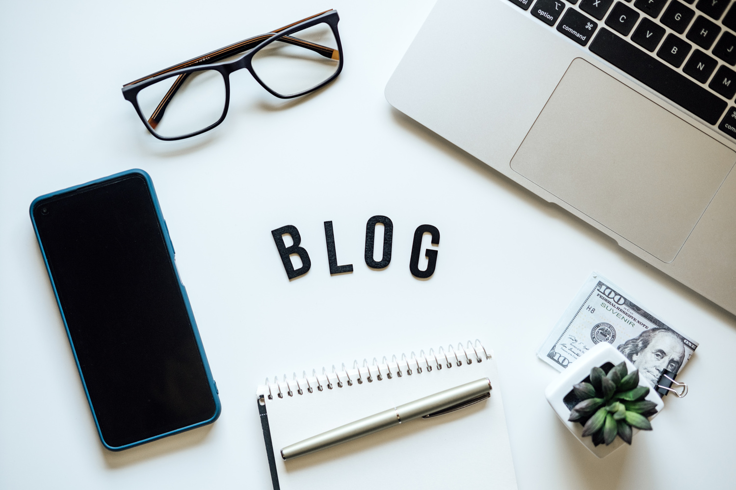 How To Start Blog, Blogging for Beginners. Ways to monetize your blog. Blog word on table with laptop, smartphone, open notebook, dollar banknotes and glasses